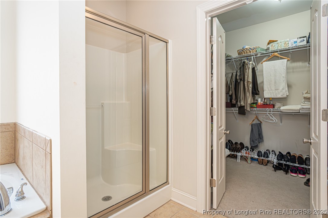 198 Grouse Run Raeford, NC 28376 - Photo 33 of 38 a view of a walk in closet and bathroom