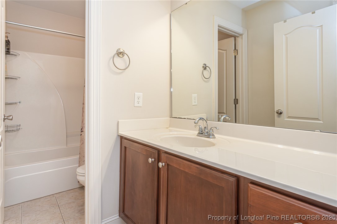 198 Grouse Run Raeford, NC 28376 - Photo 34 of 38 a bathroom with a granite countertop bathtub sink and mirror