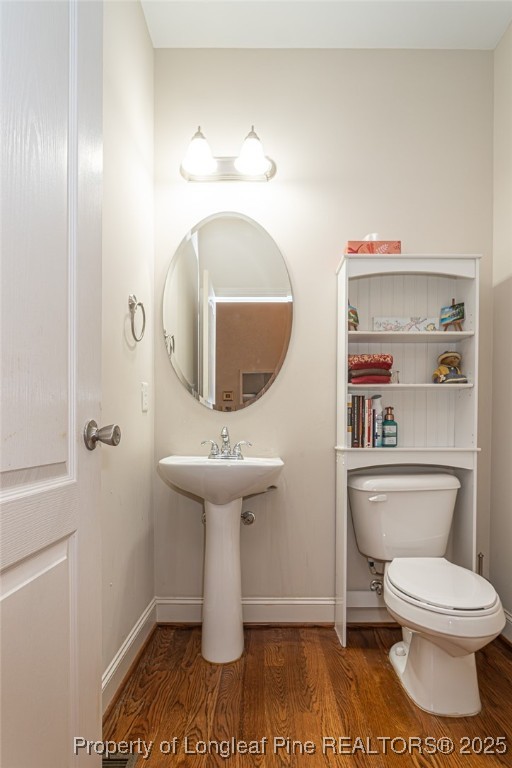 198 Grouse Run Raeford, NC 28376 - Photo 36 of 38 a bathroom with a toilet a sink and mirror