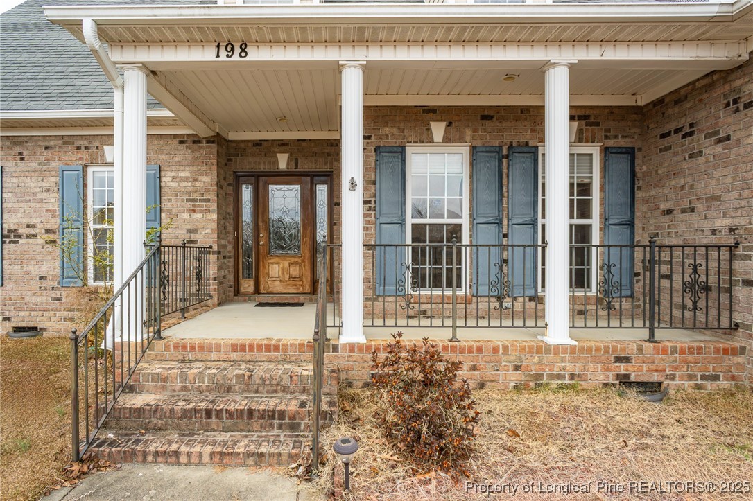 198 Grouse Run Raeford, NC 28376 - Photo 10 of 38 a view of a brick house with large windows