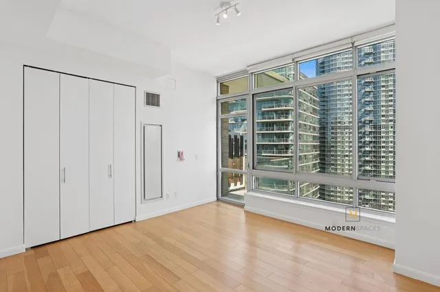 a bathroom with a granite countertop double vanity sink and a mirror
