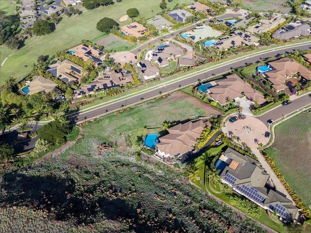 an aerial view of a city with lots of residential buildings and ocean view in back