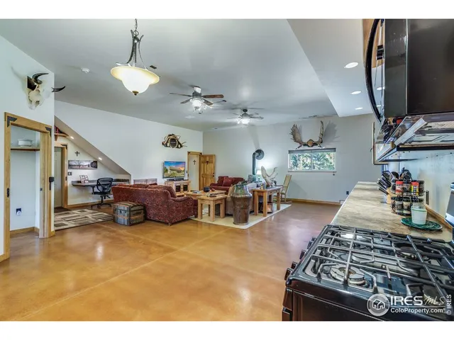 a living room with lots of furniture and kitchen view