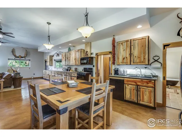 a dining room with wooden floor and chandelier