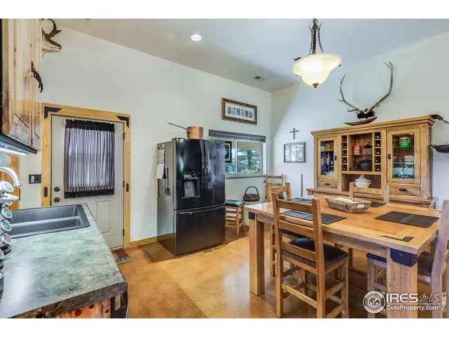 a kitchen with stainless steel appliances kitchen island granite countertop a refrigerator a stove top oven a sink and dishwasher