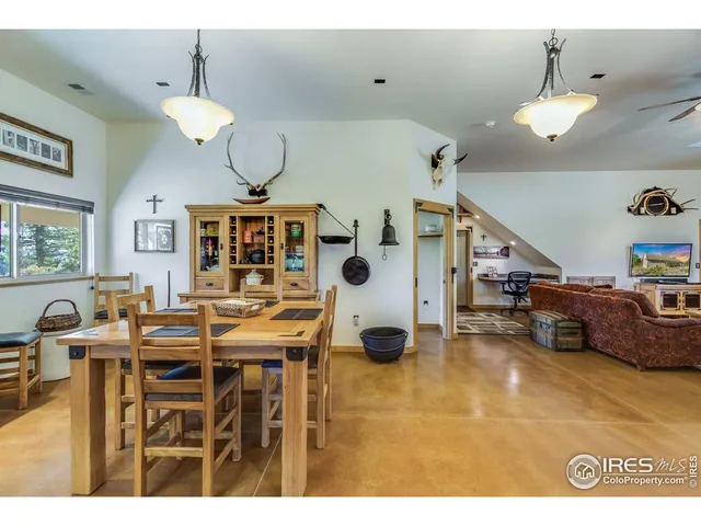 a living room with furniture and a kitchen