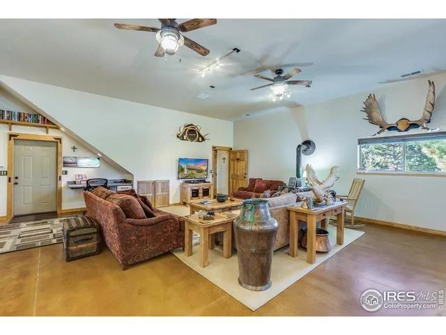 a living room with furniture and kitchen view