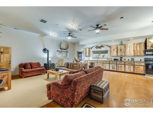 a living room with furniture a chandelier and a flat screen tv