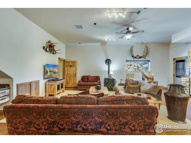 a living room with furniture kitchen view and a chandelier
