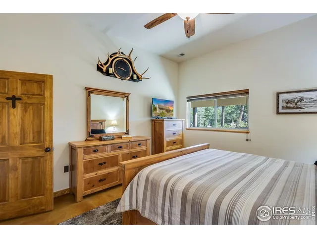 a bedroom with a bed and a night stand