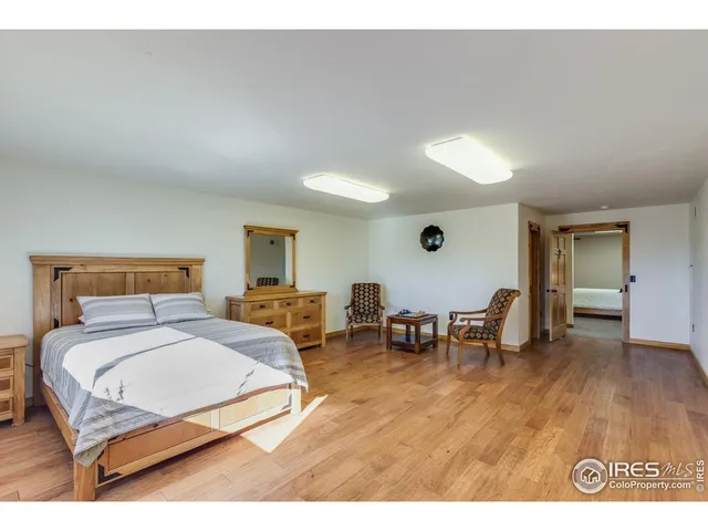 a view of a room with furniture and wooden floor