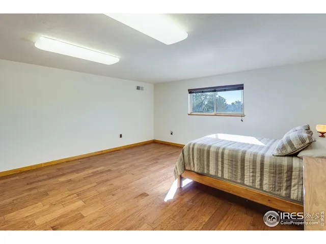 a bedroom with a bed and a view of living room