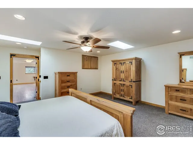 a bathroom with a granite countertop sink toilet and a mirror