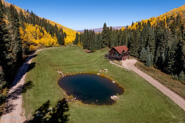 a green field with lots of trees