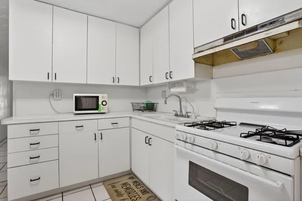 a kitchen with cabinets and appliances