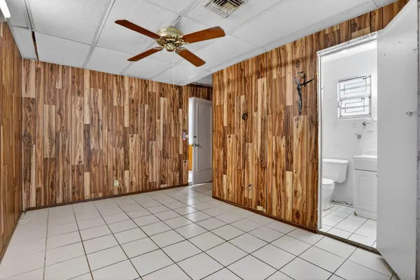 a view of a room with a shower curtain and a toilet