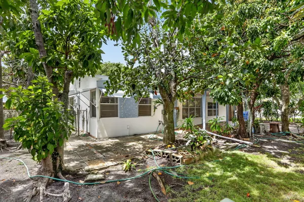 a backyard of a house with table and chairs