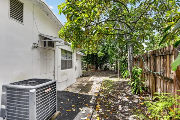 a backyard of a house with table and chairs