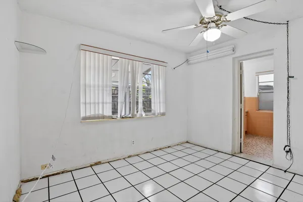 a view of an empty room with a fan