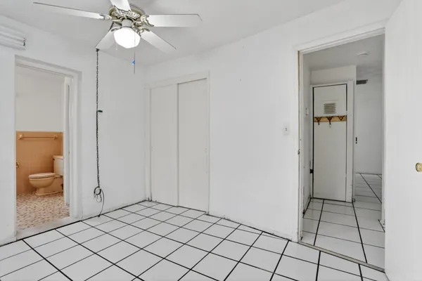 a view of an empty room and bathroom