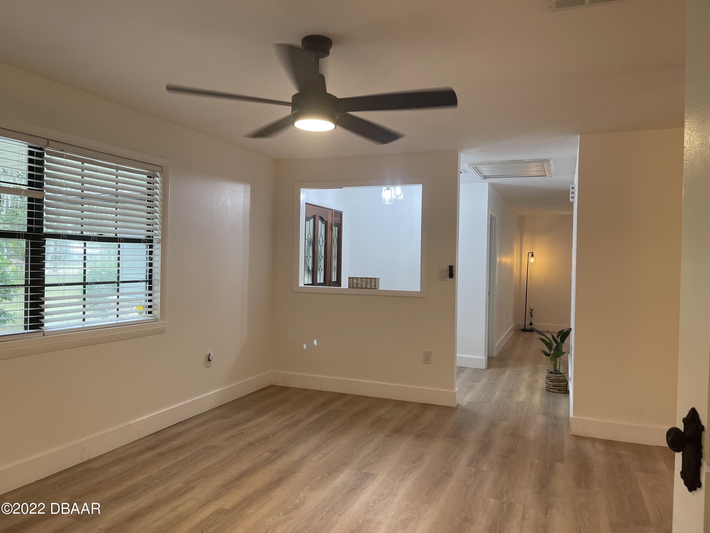 4486 Daugharty Road DeLand, FL 32724 - Photo 20 of 23 a view of empty room with wooden floor
