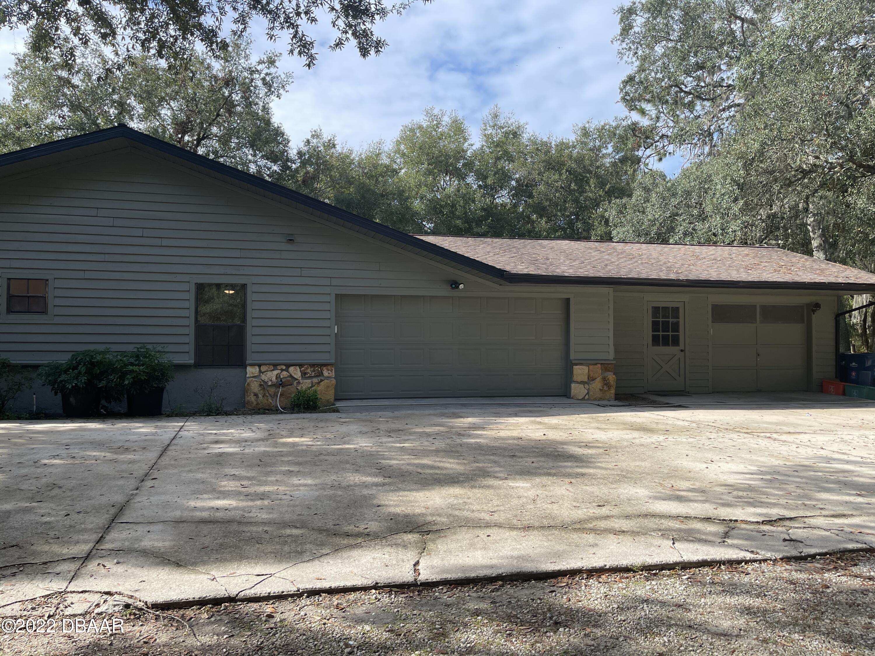 4486 Daugharty Road DeLand, FL 32724 - Photo 3 of 23 a house with trees in the background