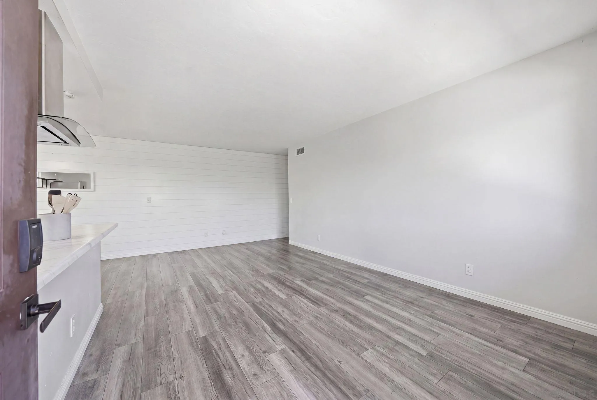 9926 Mission Vega Road, Unit 4 Santee, CA 92071 - Photo 4 of 30 an empty room with wooden floor and windows