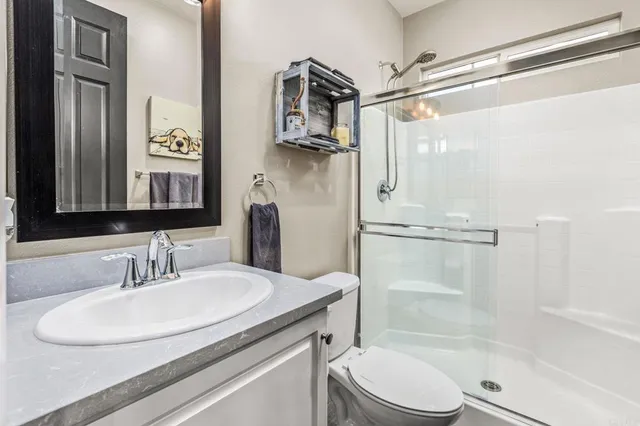 a bathroom with a sink toilet and shower