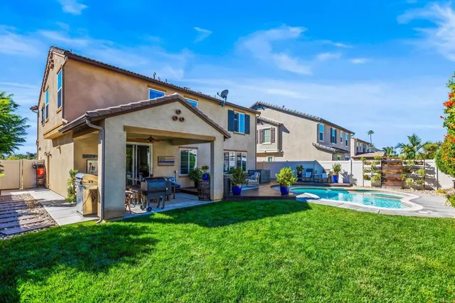 a front view of a house with a garden and plants