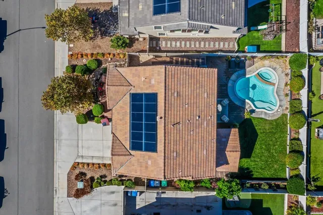an aerial view of a house with a swimming pool outdoor seating and yard