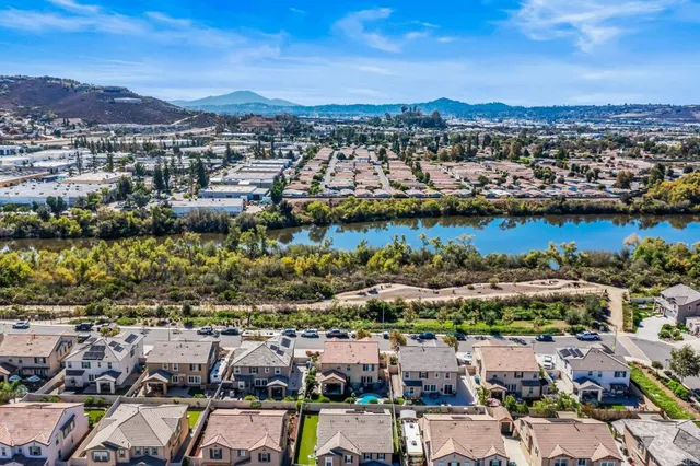 an aerial view of residential houses with city view