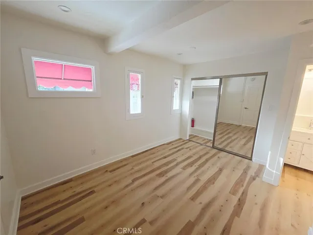 a bedroom with bed and cupboard