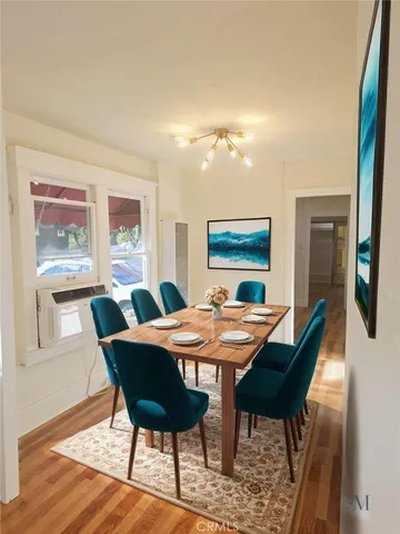 a view of a dining room with furniture window and wooden floor