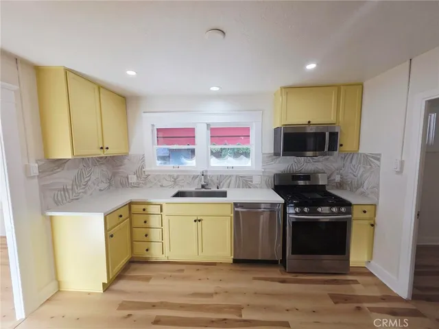 a kitchen with a stove a sink and a microwave