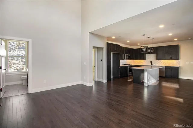 a open kitchen with a sink and white cabinets