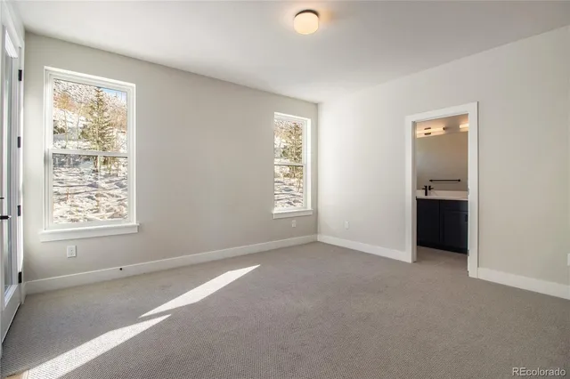 an empty room with windows and closet