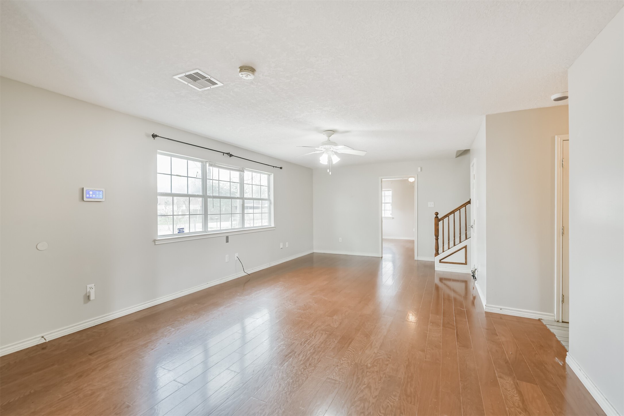 1103 Williams Street Cleveland, TX 77327 - Photo 11 of 32 wooden floor in an empty room with a window