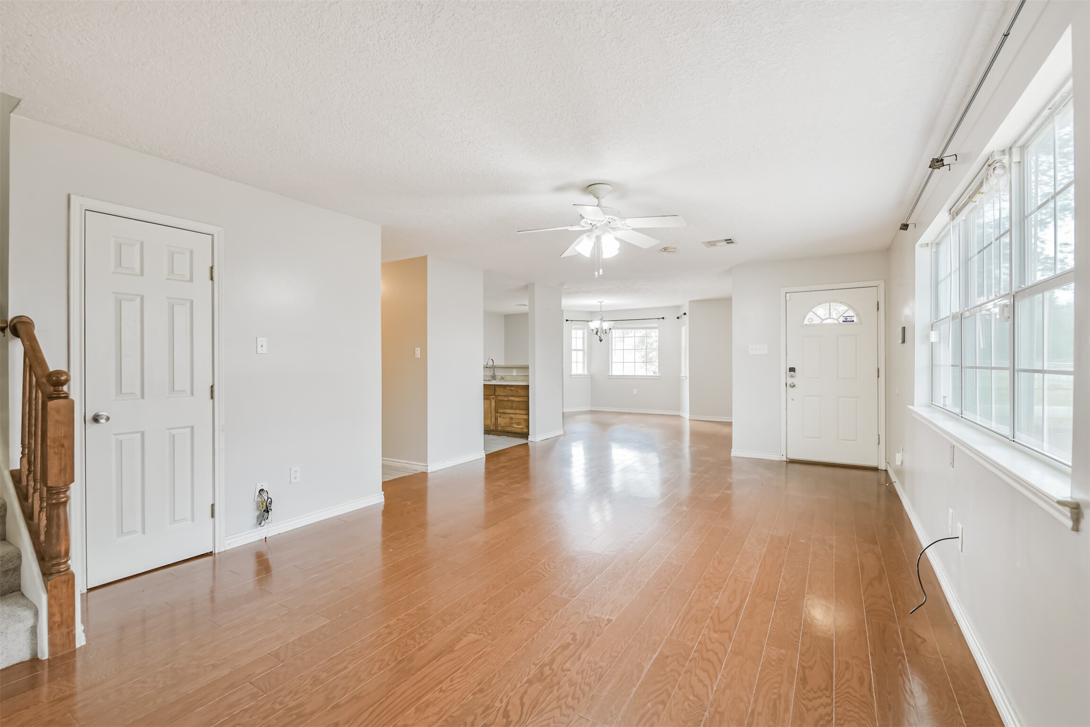 1103 Williams Street Cleveland, TX 77327 - Photo 12 of 32 a view of an empty room with wooden floor and a window