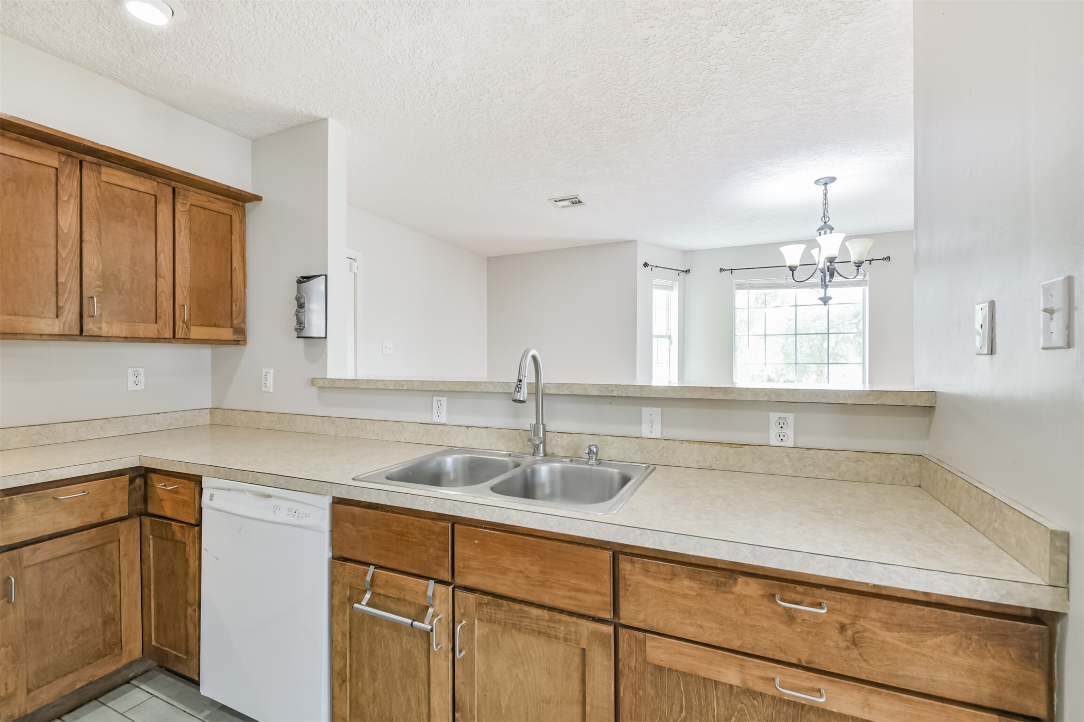 1103 Williams Street Cleveland, TX 77327 - Photo 16 of 32 a kitchen with a sink cabinets and window