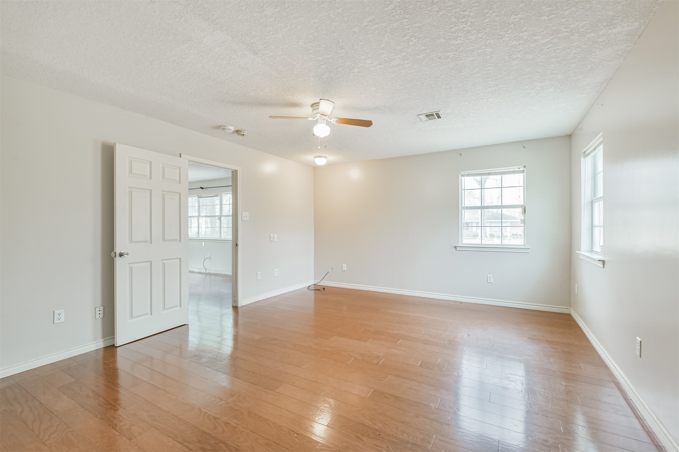 1103 Williams Street Cleveland, TX 77327 - Photo 21 of 32 wooden floor in an empty room with a window