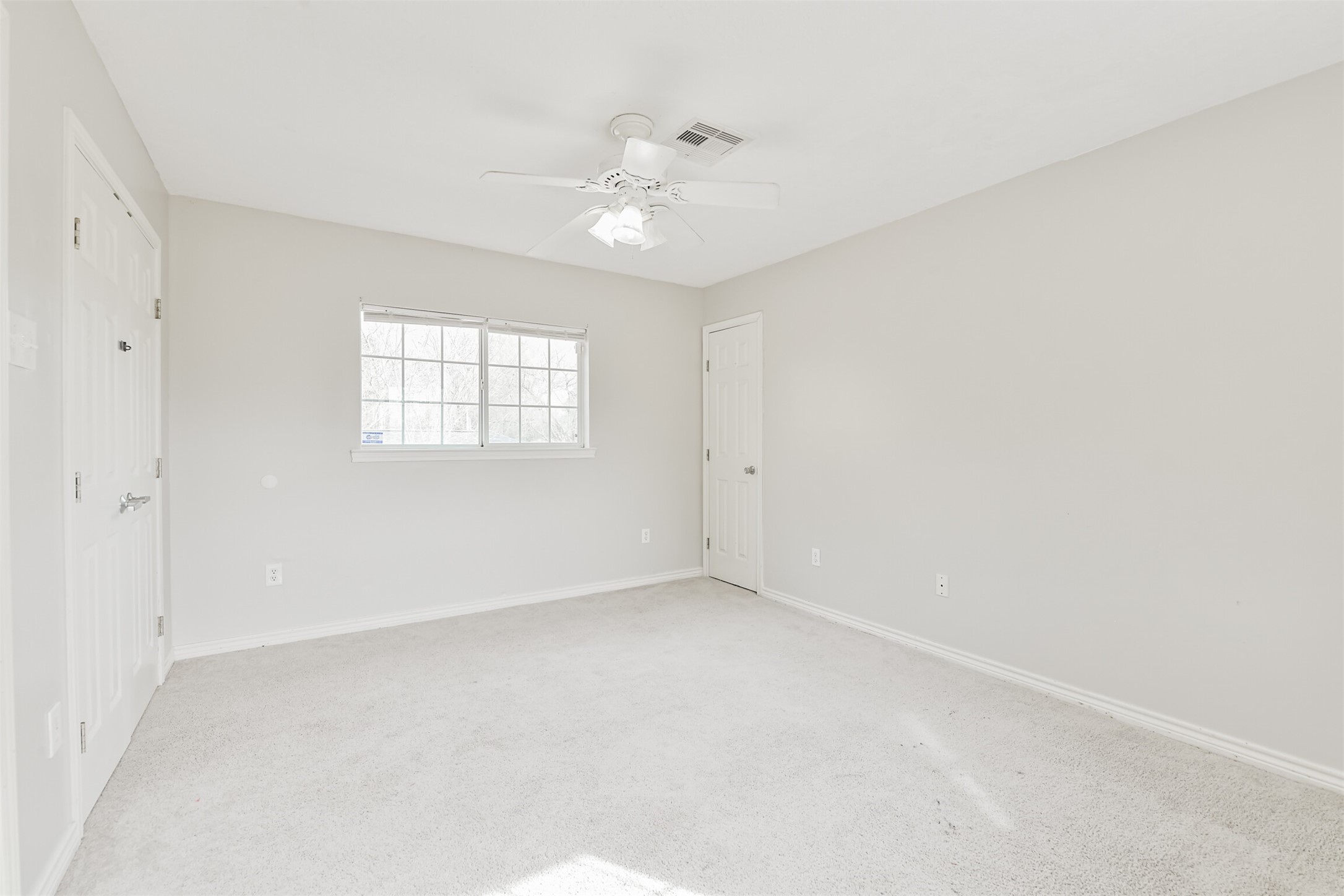 1103 Williams Street Cleveland, TX 77327 - Photo 28 of 32 an empty room with windows and chandelier fan