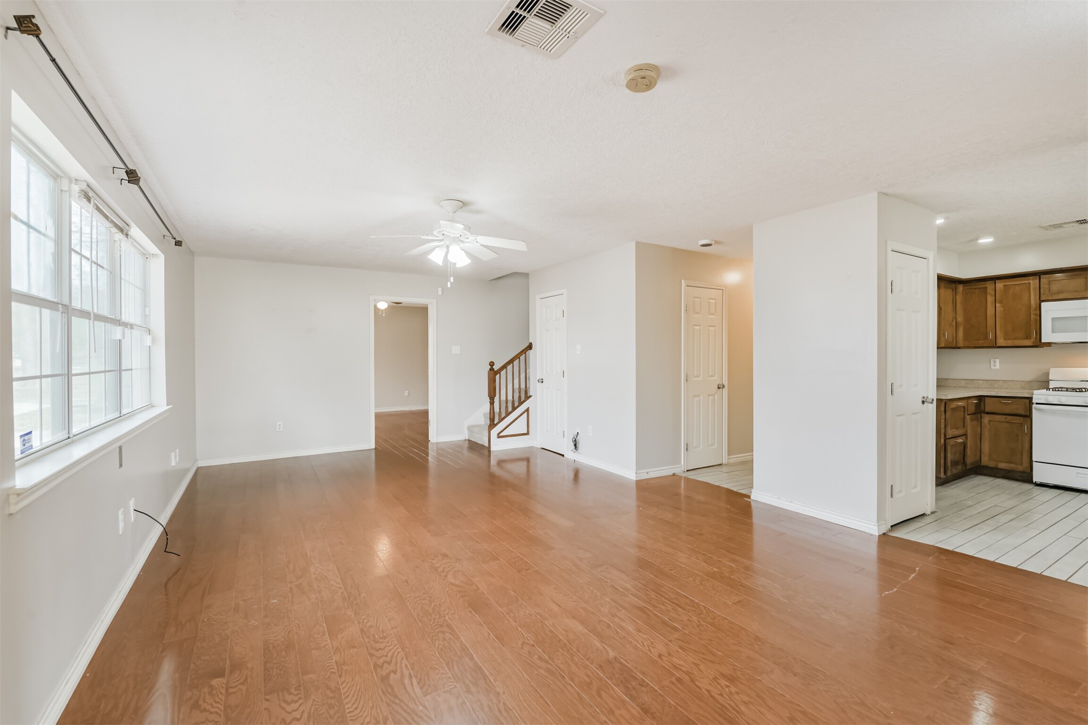 1103 Williams Street Cleveland, TX 77327 - Photo 10 of 32 a view of an empty room with window and wooden floor