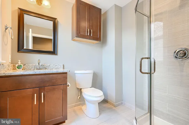 a bathroom that has a glass shower door