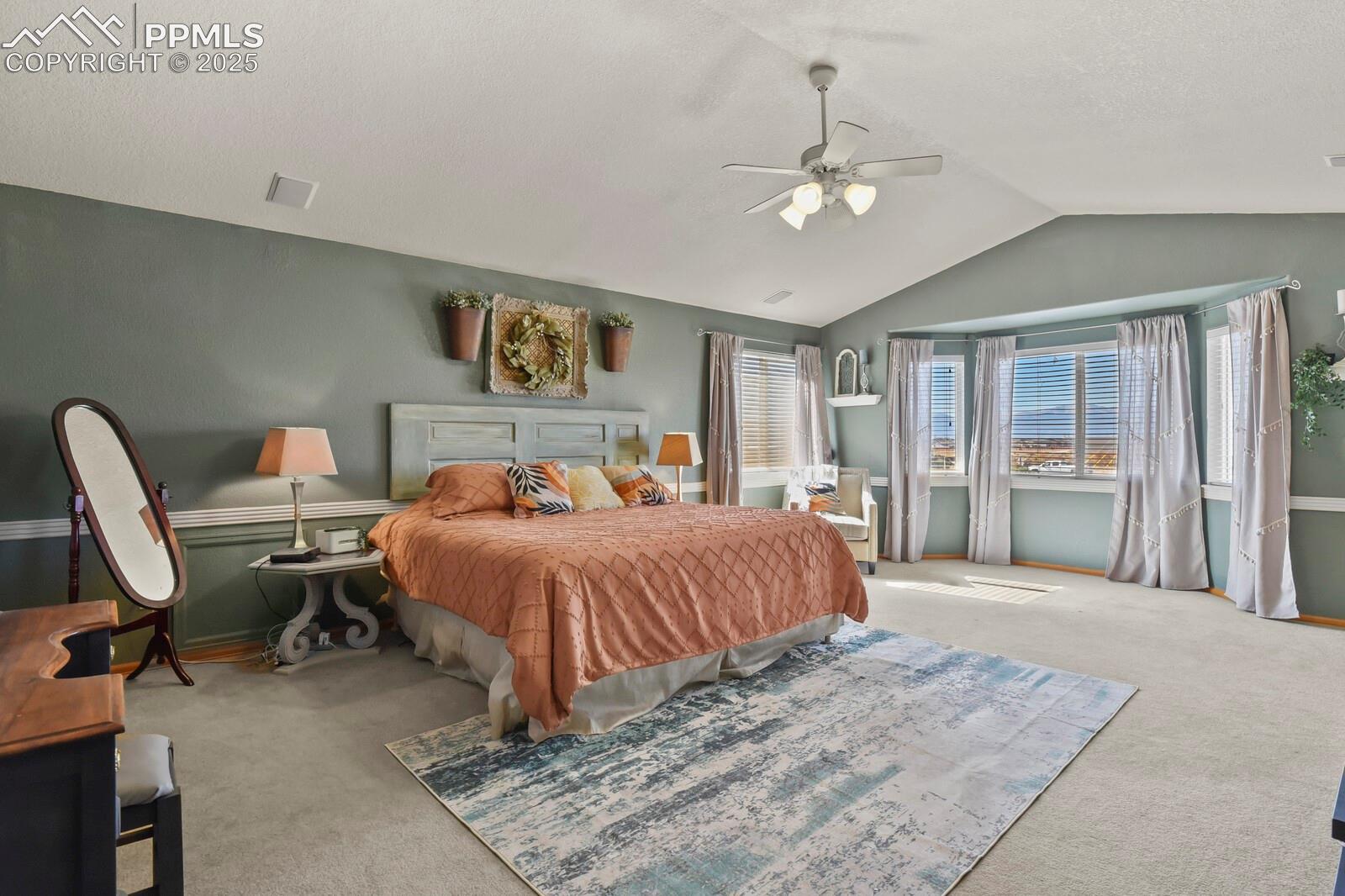 7660 Bullet Road Peyton, CO 80831 - Photo 21 of 50 Carpeted bedroom featuring lofted ceiling, a ceiling fan, and a textured ceiling