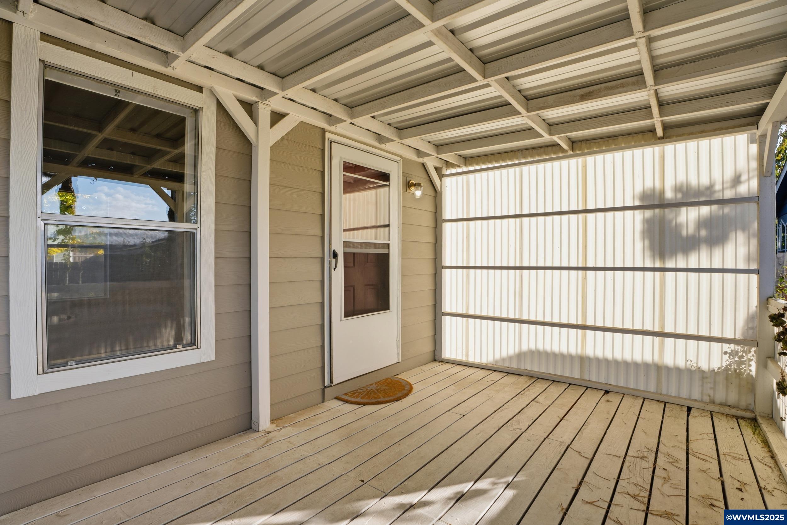 277 Edwards Road, Unit 145 Monmouth, OR 97361 - Photo 34 of 47 a view of a balcony with wooden floor and door
