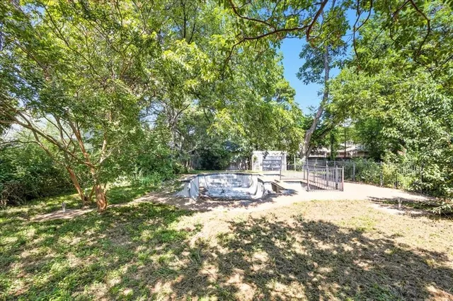 a view of a yard with swimming pool