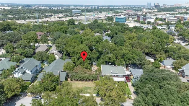 an aerial view of residential house with outdoor space and trees