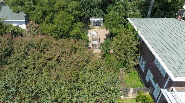 a aerial view of a house with a yard and fountain in middle
