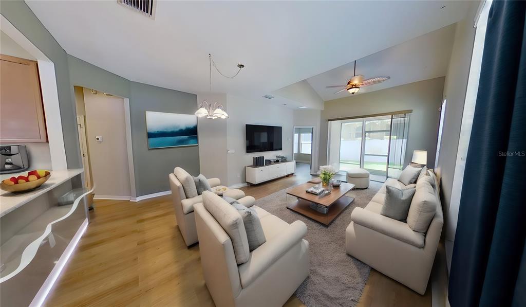 10620 Whittington Court Largo, FL 33771 - Photo 11 of 68 a living room with furniture flat screen tv and large window