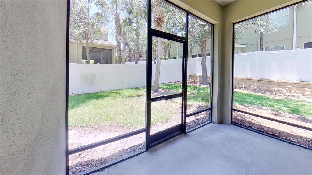 10620 Whittington Court Largo, FL 33771 - Photo 23 of 68 a view of an empty room with wooden floor and a large window